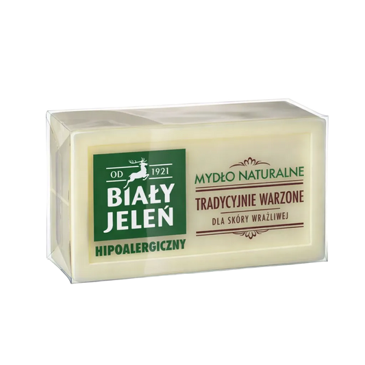 Bar of soap in packaging with 'Bialy Jelen' branding on a light gray background