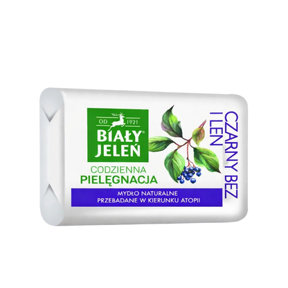 Bar of soap with branding and natural elements on a light purple background