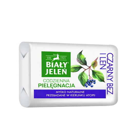 Bar of soap with branding and natural elements on a light purple background