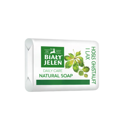 Bar of Bialy Jelen natural soap with green label on a white background