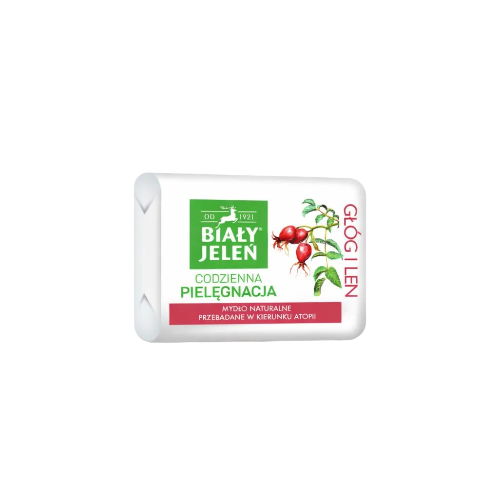 Bar of soap with a white packaging featuring green and red elements on a light gray background