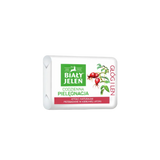 Bar of soap with a white packaging featuring green and red elements on a light gray background
