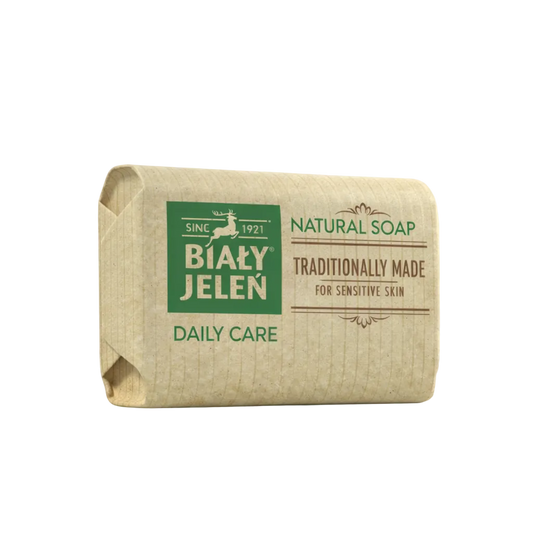 Bar of natural soap with Bialy Jelen branding on a light background