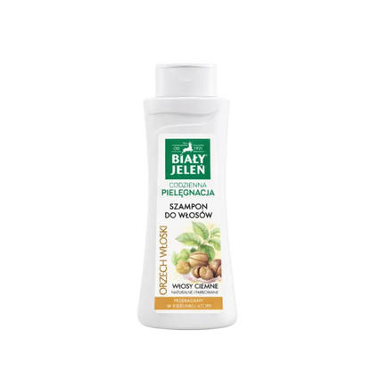 Bottle of Bialy Jelen shampoo with a green label on a light beige background