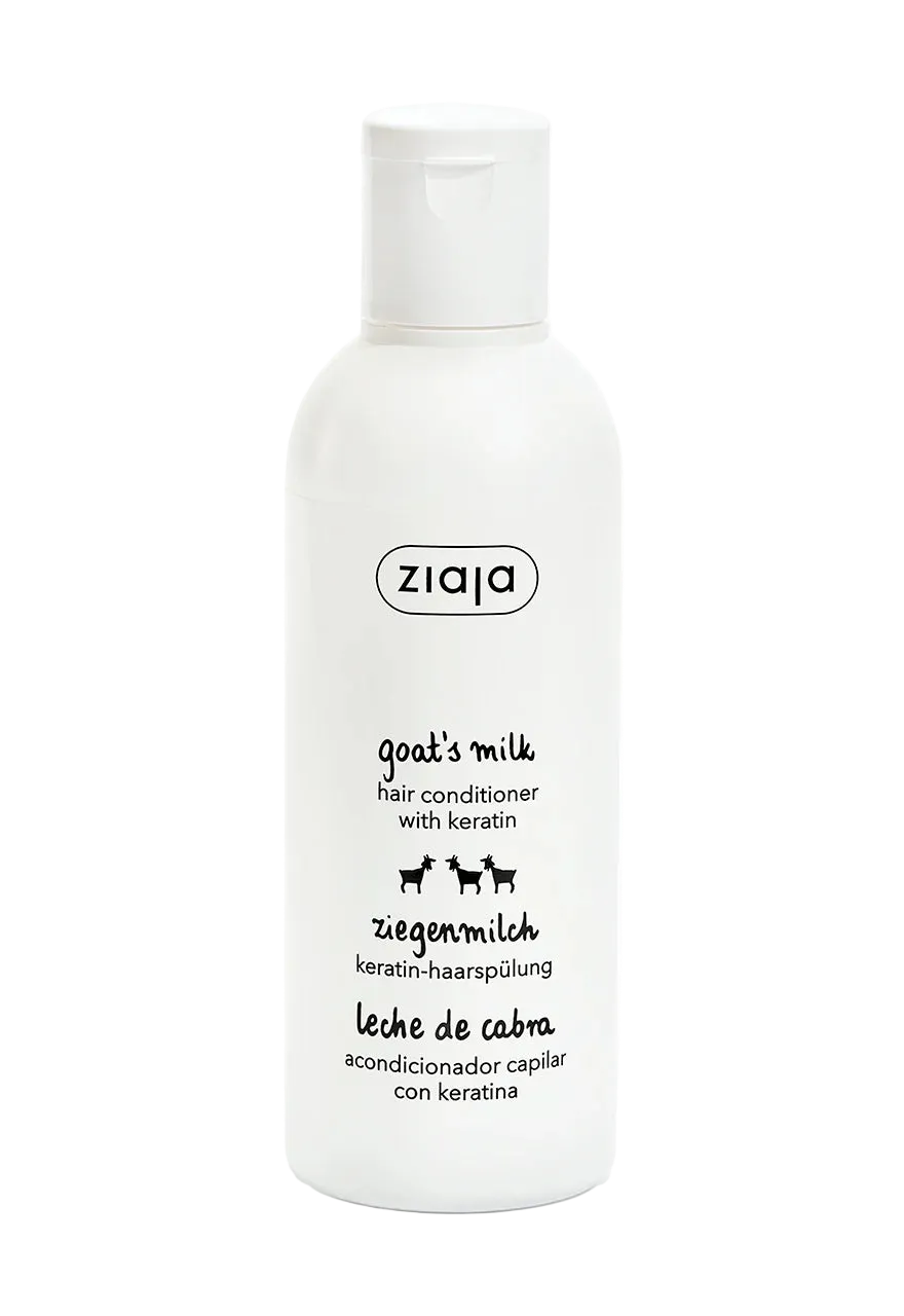 A white plastic bottle of ziaja Goat's Milk Hair Conditioner with Keratin, featuring black text and small goat illustrations on a clean white background.