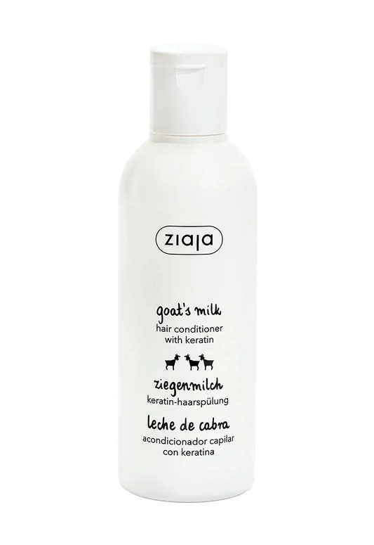 A white plastic bottle of ziaja Goat's Milk Hair Conditioner with Keratin, featuring black text and small goat illustrations on a clean white background.