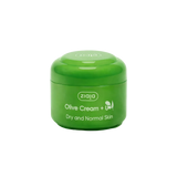 Green jar of Ziaja Olive Cream on a light green background