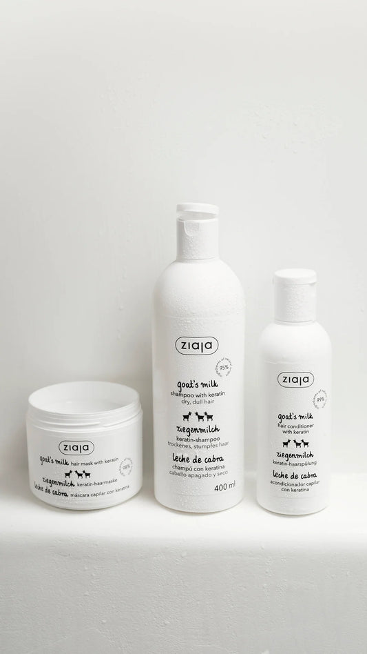 Three white pet grooming products from the brand ziqo, including a jar, a medium bottle, and a smaller bottle, arranged on a light gray surface against a white background.